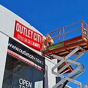 Outlet City Installing new fascia logo