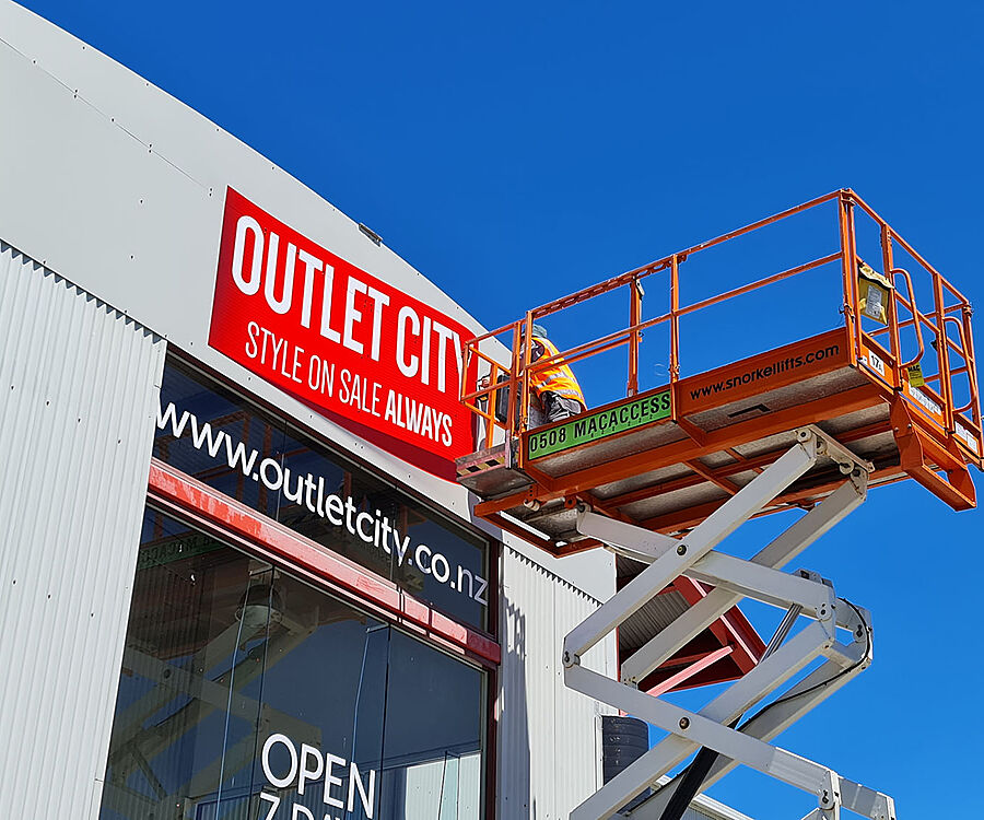 Outlet City Installing new fascia logo