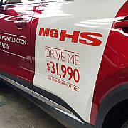 White stripe vinyl wrap on red vehicle with promotional graphics